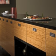 View of a bedroom which features cabinetry from cabinetry, chest of drawers, countertop, drawer, furniture, hardwood, kitchen, sideboard, table, wood, wood stain, black, brown