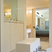 View of contemporary light-toned bathroom off bedroom with architecture, bathroom, bathroom accessory, bathroom cabinet, countertop, floor, home, interior design, kitchen, real estate, room, sink, orange