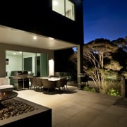 View of sleek poolscape with textured stone wall, architecture, estate, home, house, interior design, lighting, property, real estate, window, brown, black