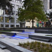 View of St Patrick's square featuring landscaping, paving, architecture, building, city, condominium, daytime, downtown, metropolitan area, mixed use, neighbourhood, plant, plaza, reflection, residential area, tree, urban area, urban design, gray, black