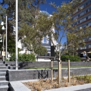 Exterior view of St Patrick's Square which features architecture, building, city, condominium, neighbourhood, plant, real estate, residential area, sky, tree, walkway, gray