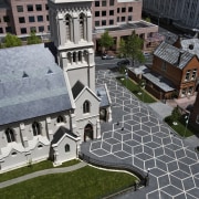 Exterior view of St Patrick's Square which features architecture, building, city, facade, house, neighbourhood, outdoor structure, residential area, roof, urban area, gray, black