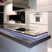 Interior view of this contemporary kitchen featuring LED countertop, home appliance, interior design, kitchen, product design, gray, black