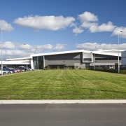 Exterior view of the brewhouse which was constructed architecture, asphalt, corporate headquarters, grass, infrastructure, real estate, residential area, sky, structure, gray