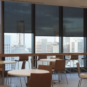 Interior view of 34-Story building with blinds from architecture, classroom, daylighting, furniture, institution, interior design, office, table, window, black, brown