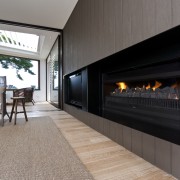 View of a living area which features a fireplace, hearth, interior design, gray, black