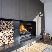 View of a living area which features a fireplace, hearth, heat, interior design, wood burning stove, gray, black