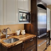 View of a kitchen which features white quartz cabinetry, countertop, cuisine classique, home appliance, interior design, kitchen, major appliance, room, gray, brown