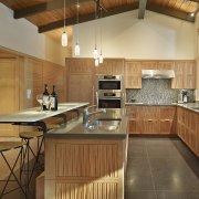 View of the kitchen area - View of cabinetry, ceiling, countertop, cuisine classique, flooring, hardwood, interior design, kitchen, real estate, room, wood, wood flooring, brown, orange