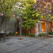 View of private courtyard which features native planting, backyard, cottage, courtyard, estate, facade, garden, home, house, landscape, landscaping, outdoor structure, patio, plant, property, real estate, residential area, tree, walkway, yard, brown, gray