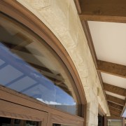 Exterior view of an energy-efficient home which was architecture, beam, ceiling, daylighting, roof, structure, window, wood, brown