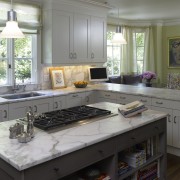 Interior view of the kitchen. Features kitchen island cabinetry, countertop, cuisine classique, kitchen, room, gray