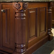 View of traditional trimmings on the kitchen island. cabinetry, chest of drawers, countertop, drawer, floor, flooring, furniture, hardwood, kitchen, sideboard, wood, wood stain, red, brown