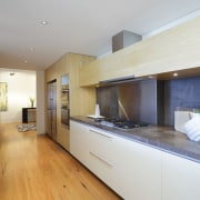 View of the kitchen area which features timber countertop, floor, flooring, interior design, kitchen, property, real estate, room, wood flooring, gray