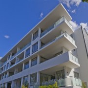 Exterior view of the eko by Crown apartments. apartment, architecture, building, commercial building, condominium, corporate headquarters, elevation, estate, facade, home, hotel, house, mixed use, property, real estate, residential area, sky, tower block, blue, gray