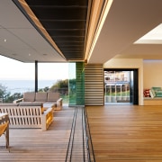 View of open-plan living space which features clay-based apartment, balcony, daylighting, estate, floor, home, house, interior design, real estate, roof, wood, orange