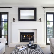 View of the lounge area which features sofas, ceiling, fireplace, floor, hearth, home, interior design, living room, room, window, white