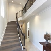 View of stairway which features iron balustrade and architecture, baluster, ceiling, daylighting, estate, floor, flooring, handrail, home, house, interior design, real estate, stairs, gray, white