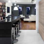 View of a renovated kitchen which features a floor, flooring, furniture, interior design, kitchen, office, wood flooring, gray, black