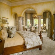 View of master bedroom that features archways and bed, bed frame, bedroom, ceiling, estate, furniture, home, interior design, living room, property, real estate, room, window, brown, orange