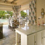 View of kitchen and family living area with countertop, estate, floor, flooring, home, interior design, kitchen, property, real estate, table, window, brown, orange