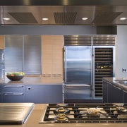 View of contemporary condominium kitchen which features aluminium countertop, home appliance, interior design, kitchen, gray, black