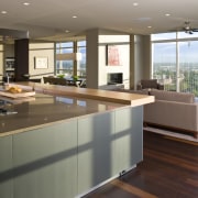 View of contemporary condominium kitchen which features aluminium countertop, floor, interior design, kitchen, real estate, gray, brown