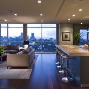 View of contemporary condominium kitchen which features aluminium ceiling, countertop, interior design, living room, real estate, brown