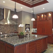 View of the cabinetry within this modern kitchen. cabinetry, ceiling, countertop, cuisine classique, flooring, home, interior design, kitchen, real estate, room, gray, red