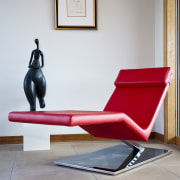 View of living area which features leather lounger chair, chaise longue, couch, floor, flooring, furniture, product design, sitting, table, gray, white