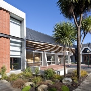 Courtyard view features an inner garden with native apartment, architecture, building, condominium, corporate headquarters, courtyard, estate, facade, home, house, mixed use, neighbourhood, plant, property, real estate, residential area, sky, tree, black