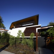 Exterior view of this contemporary home by Arkhefield architecture, facade, home, house, outdoor structure, real estate, residential area, roof, sky, blue, black