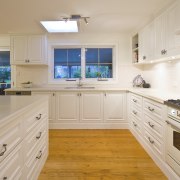 Interior view of this traditional kitchen - Interior cabinetry, countertop, cuisine classique, floor, flooring, home, interior design, kitchen, property, real estate, room, window, wood flooring, gray, orange