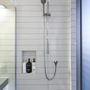 Shower with white wall tiles. - Shower with bathroom, plumbing fixture, shower, tap, wall, gray