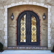 View of the entrance way which features Iron arch, door, facade, iron, structure, window, gray