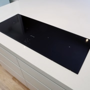 View of contemporary cooktop on white benchtop. - bathroom sink, countertop, hardware, plumbing fixture, product design, sink, white