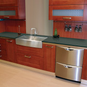 View of kitchen which features sink and arched cabinetry, countertop, cuisine classique, drawer, floor, furniture, hardwood, interior design, kitchen, kitchen stove, room, red