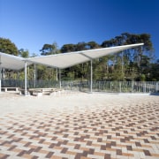 Exterior view of the paving at Albany Senior architecture, cloud, estate, floor, outdoor structure, real estate, residential area, road surface, sky, structure, walkway, white, blue