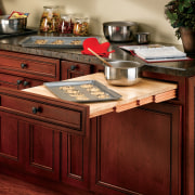 View of cabinetry which features storage systems from cabinetry, chest of drawers, countertop, cuisine classique, drawer, furniture, hardwood, kitchen, table, wood, wood stain, red