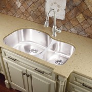 View of kitchen which features sink and arched bathroom sink, countertop, plumbing fixture, sink, tile, brown, gray