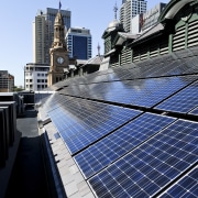 View of the renovated Sydney town hall featuring building, city, daytime, downtown, energy, metropolis, metropolitan area, roof, sky, skyscraper, urban area, water