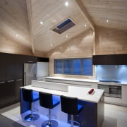 View of the contemporary kitchen area which features architecture, ceiling, daylighting, floor, furniture, house, interior design, table, gray