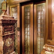 View of lifts in the renovated historic Sydney door, wood, orange, brown