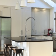 View of renovated kitchen which features timber floors, countertop, home, interior design, kitchen, light fixture, product design, table, gray