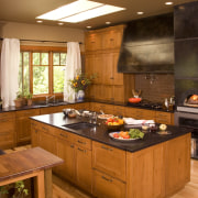 View of a Northwestern-styled kitchen with extensive wood cabinetry, countertop, cuisine classique, hardwood, interior design, kitchen, room, brown