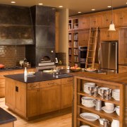 View of a Northwestern-styled kitchen with extensive wood cabinetry, countertop, cuisine classique, flooring, hardwood, interior design, kitchen, room, wood stain, brown