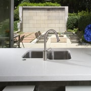 View of kitchen featuring island with CaesarStone countertops, architecture, countertop, sink, tap, white