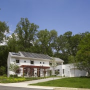 Exterior view of this contemporary remodeled home - architecture, cottage, elevation, estate, facade, farmhouse, home, house, land lot, landscape, neighbourhood, property, real estate, residential area, suburb, tree, brown, blue