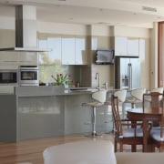 View of the kitchen area of this contemporary floor, home, interior design, kitchen, living room, room, table, gray