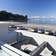 View of the exterior of this modern home sea, sky, water, white, teal